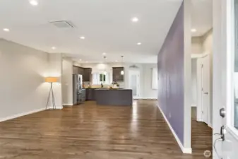 Front door entry into the living room that is open to the kitchen and dining room to the right. The hallway to the right with two bedrooms and full bath separates the two bedrooms in the hall. Entry closet to the right.