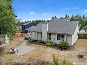 The backyard features different entertaining areas:  private deck, paved patio and large firepit area!