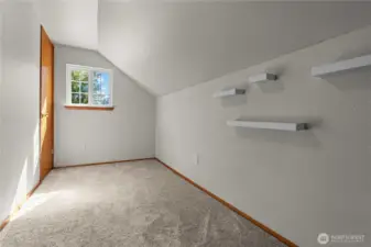 Fourth bedroom space with floating shelving.