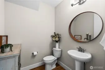 Located off the kitchen and great room, the powder room is spacious and convenient.