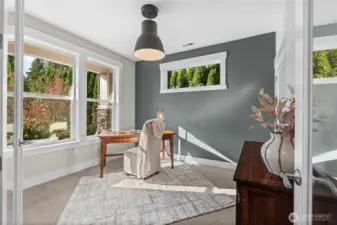 A large office, bathed in natural light and with views of the front yard offers a beautiful place to call your work space