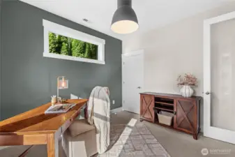 Sunlight filters through the transom window, offering tranquil backyard views, while a well-sized closet ensures a clean and organized workspace.