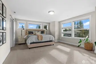 Simply stunning! This primary ensuite bedroom exudes glamour, flooded with natural light and featuring motorized blinds for modern convenience. Spacious enough for a cozy settee, it’s a truly wondrous retreat.