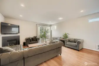 Spacious living room w/ gas fireplace and access to rear deck