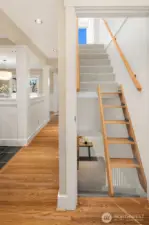 Ship's Ladder steps to Architect Loft are hinged and fold up to the wall to the right for more open access to the Lower Level.