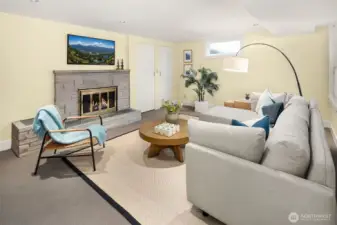 Lower Level - 3rd conforming bedroom with wood burning fireplace staged as rec room