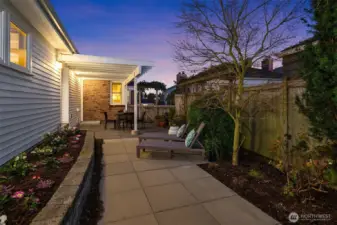 South side of house fully-fenced for private, outdoor relaxation.