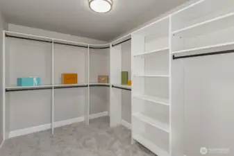 Extra-large Primary walk-in closet with custom organizing system.