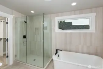Luxury details abound in the Primary bathroom from the frameless shower to the deep soaking tub and extensive use of tile.