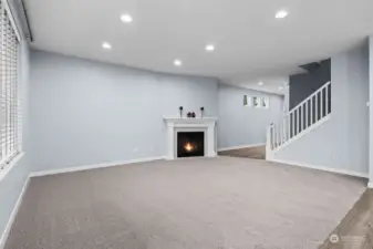 From the Kitchen looking back toward the Entry, you see this beautiful Gas Fireplace accented by the white mantle and surround.