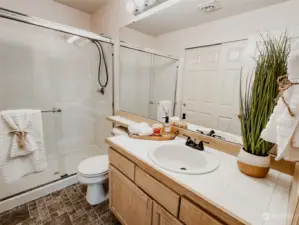 Enjoy the convenience of a glass-enclosed walk-in shower, offering a refreshing way to start your day