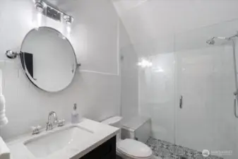 Main level guest bathroom with walk-in shower.