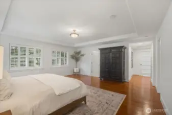 Primary Suite also features large window with wood shutters.