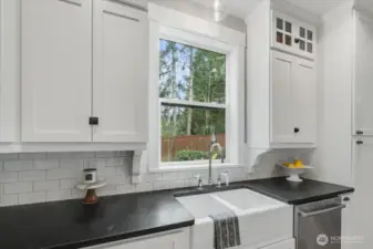 Kitchen features farmhouse sink.