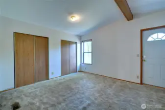 Primary bedroom with exterior door leading to patio and backyard.