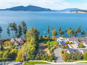 Clearing of brush on water's edge can be done to open up the view as show by the other homes in the neighborhood to the right of lot #1.