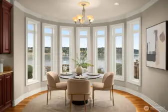Lake-filled dining nook framed by a wall of windows overlooking the lake.