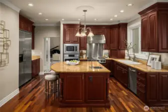 Kitchen centered around a large island designed to flow easily into the surrounding living spaces.
