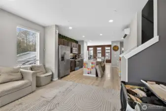 Seamless open-concept floor plan elegantly connecting the living, dining, and kitchen areas