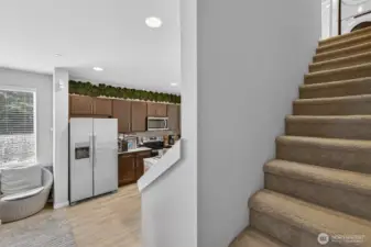 Elegant staircase with open views to the kitchen and main living areas below