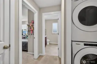 3rd floor laundry area with full-size stacked washer and dryer, conveniently located on the bedroom level