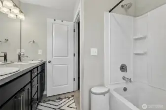 Master suite full bathroom with double sink vanity, walk-in shower, and elegant high-end fixtures