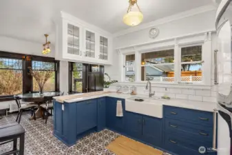 Timeless details shine in this chef-worthy kitchen, featuring a farmhouse sink, classic subway tile, marble counter tops, and a statement vintage-style refrigerator—where old-world character meets contemporary convenience.