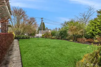 A level, fully enclosed lawn offers rare green space in downtown Snohomish, surrounded by established landscaping that provides both privacy and beauty.