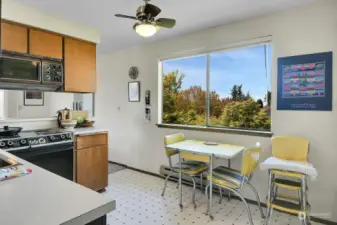 Unit #3:  Kitchen eating space with west-facing view window overlooking peek view of Olympic Mountains.