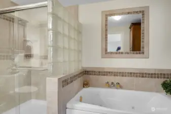 Unit #1:  Completely remodeled primary bathroom, including jetted tub, tile and walk in shower.