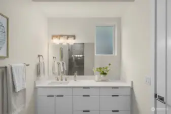 Primary ensuite features white quartz countertops and a ceramic tile walk-in shower.