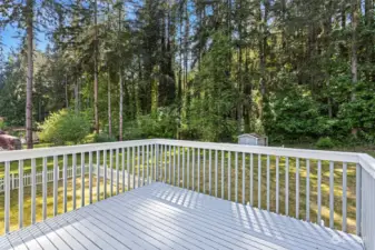 Large deck overlooks serene yard