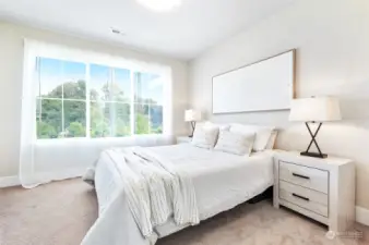 Additional sunshine filled bedroom with large windows.