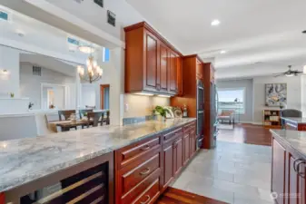 A sizeable beverage fridge is great for your white wines, mixers and extra beverages. To the right of this picture is a built-in wine rack for all of your reds and even has a space to hang your stemmed glasses. The large pass-thru window is perfect for handing dishes & drinks through to the formal dining area.