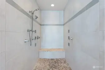 Large zero threshold shower beckons you to wash the day's cares away. The multiple shower jets, pebbled floor and relaxing bench make this shower the place to go to after a long day.