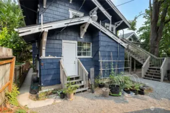 The back of the house offers privacy, and a communal garden/courtyard area. The back of the house also offers an entrance to the utility room for Unit 2.
