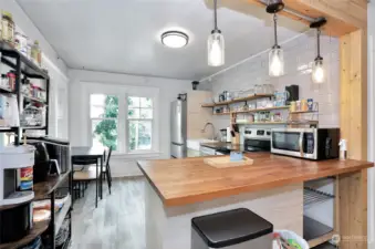 Unit 3 - Main Kitchen area features butcher block counters, modern updates and stainless steel appliances.
