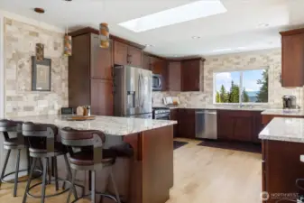 Welcoming kitchen with eating space and cherry wood cabinets.