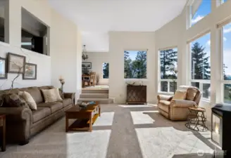 Large living room with plenty of natural light and a cozy fireplace for those winter nights.