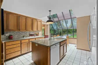 Updated kitchen featuring granite countertops, tile backsplash and Blanco sink. All kitchen appliances will stay!