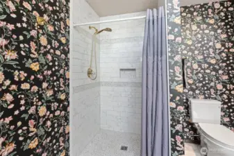Updated ensuite five-piece bath with new tile shower and waterproof laminate tile flooring