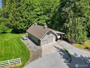 The detached 4-car garage/shop is 1,144 sq ft and features a pellet stove, 11 ft ceilings, a half bath, an upper storage loft with shelving, three doors (one 10’ and two 8’), and plenty of room for projects or storage. Plus, the attached carport accommodates up to a 48' RV, with power and hookups