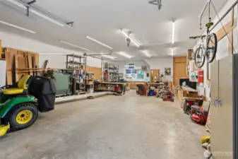 The detached 4-car garage/shop is 1,144 sq ft and features a pellet stove, 11 ft ceilings, a half bath, a upper storage loft with shelving, three doors (one 10’ and two 8’) and plenty of room for projects or storage