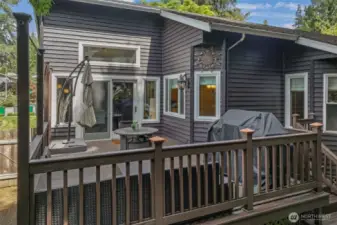French doors open to an expansive deck, offering a seamless flow from the dining room to outdoor living. Whether enjoying quiet mornings or lively gatherings, this space is a true extension of the home.