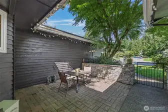 Enjoy a peaceful morning or evening in the private front patio, enclosed by a stone-accented retaining wall and surrounded by natural foliage. This functional outdoor space offers a serene transition between indoors and out.