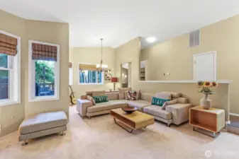 Multiple windows frame views of the surrounding landscape, while the open layout creates seamless flow for entertaining or daily living. Freshly installed carpet adds softness and comfort underfoot.