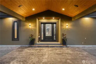 Covered front entry with stamped concrete.
