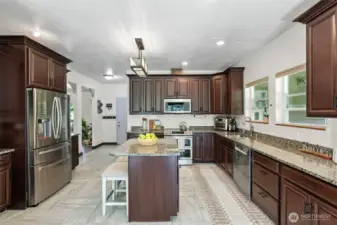 Large spacious kitchen with plenty of cabinet storage and granite countertop space. Stainless steel appliances that all convey.