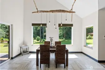 Beautiful driftwood chandelier handcrafted by the owner accentuates this dining space.