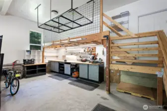 The garage also features a 20-foot premium workbench below the mezzanine, offering fantastic workspace and organization options while still allowing for full two-car parking.